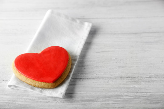 Valentine heart cookie on wooden background