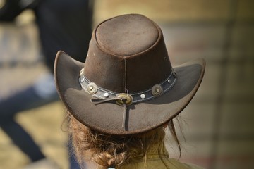 Cowgirl with hat is watching rodeo