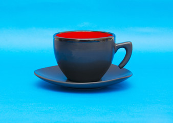 Black cup isolated on blue background