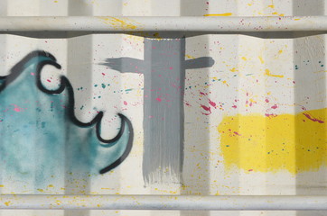 Graffiti in pastel color on white container with yellow line