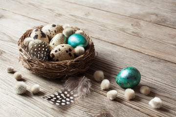 Easter nest and eggs on a wooden background