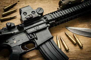 Assault rifle on a wooden table
