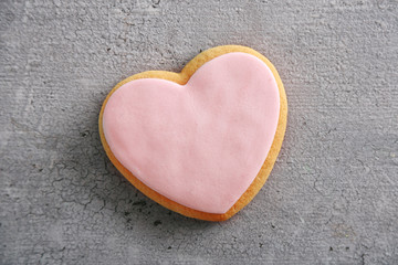 Naklejka na ściany i meble Pink love cookie on grey background, closeup