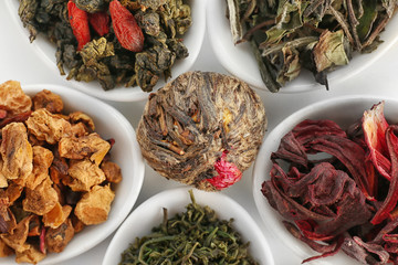 Variety of dry blossom tea in spoons, closeup
