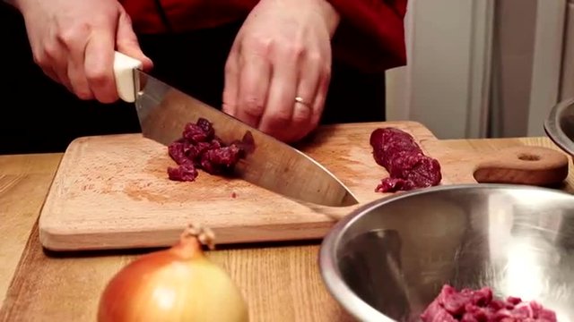 Chef cutting fresh meat for future dish. Slider shoot. Close up