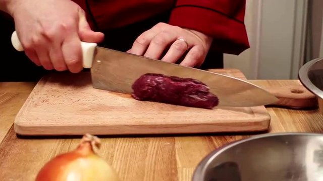 Chef cutting fresh meat for future dish. Slider shoot. Close up