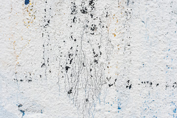 Rough wall with remains of white color paint abstract background texture