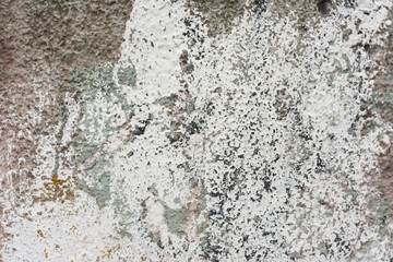 Rough wall with remains of white color paint abstract background texture