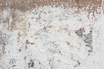 Rough wall with remains of white color paint abstract background texture