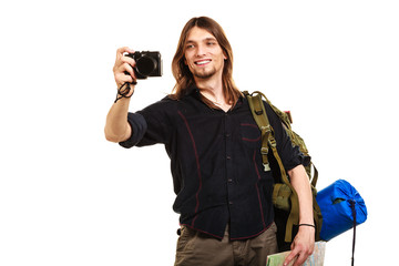 Man tourist backpacker taking photo with camera.