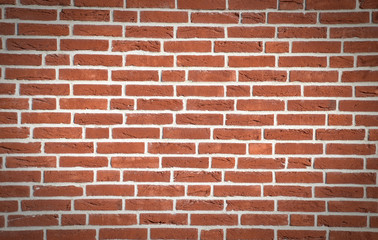 Wall made from red bricks as an background, dark vignette