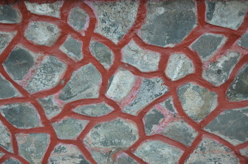 Stone wall with dark red seam