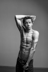 Naklejka premium artistic portraits of young topless man on gray background