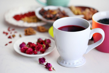 Cup of tea with aromatic dry tea on wooden background