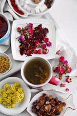 Cup of tea with aromatic dry tea on wooden background