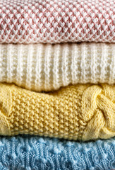 Fototapeta na wymiar Stack of knitted clothes closeup