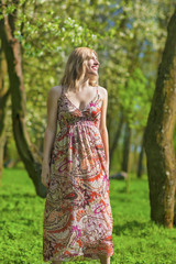 Fototapeta na wymiar Portrait of Smiling Sensual Blond Woman in Spring Forest Outdoors