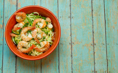 Spiralized Zucchini with jumbo shrimp on wood board