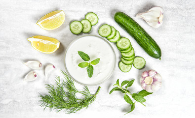 Tzatziki sauce ingredients. Yoghurt, herbs, vegetables