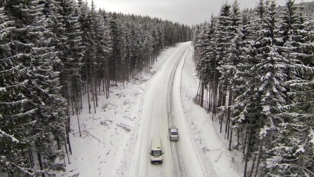 Aerial shot of snow-covered road in the countryside Carpathian Mountains