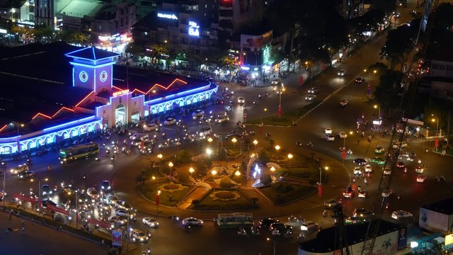 Impression, colorful, vibrant scene of traffic, dynamic, crowded city with trail on street, Quach Thi Trang roundabout at Ben Thanh market, Ho Chi Minh city (Sai Gon), Vietnam