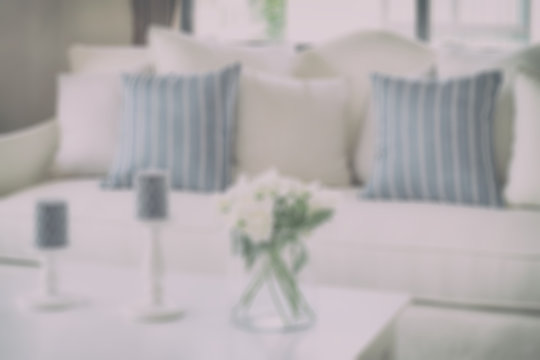 blur image of blue striped pillows on a casual sofa and decorati