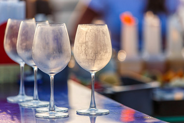 Empty glasses for wine on the table at counter bar from rooftop and restaurant , selective focus