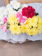 Red flowers on table of flower arrangement.