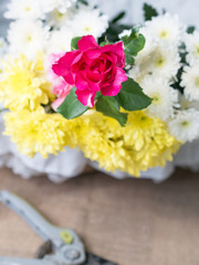 Red flowers on table of flower arrangement.