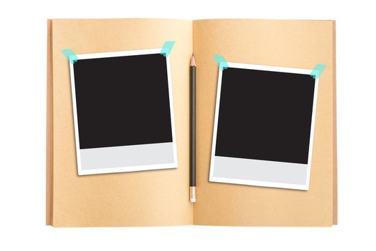 Polaroid photo frames on notebook and pencil