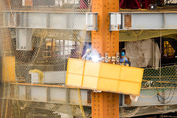 Construction workers welding on site
