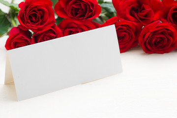 Love message on table - red roses with envelope
