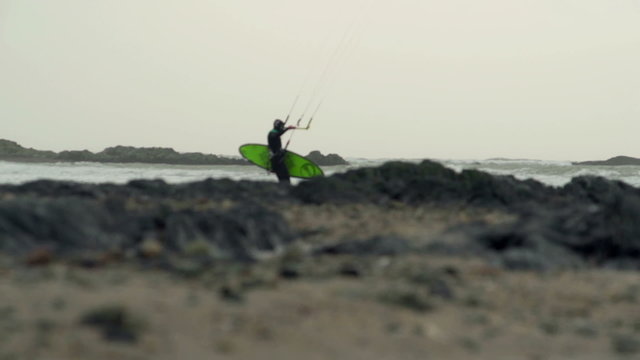 Kite surfers are surfing on large storm waves in North Wales as a stormy winter hits.