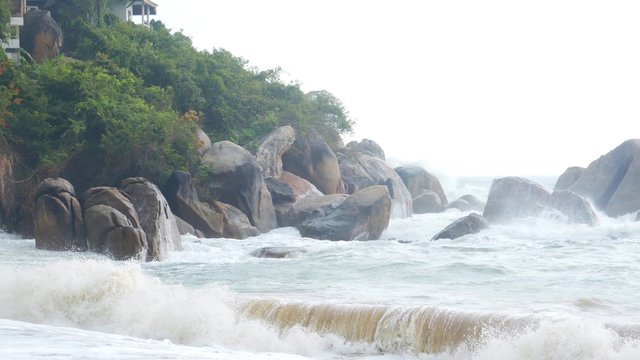 storm in the ocean, waves hitting rocks