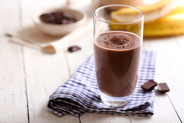 Glass of chocolate milk on table close-up