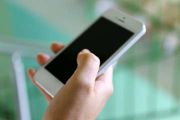 Woman holding smartphone indoors