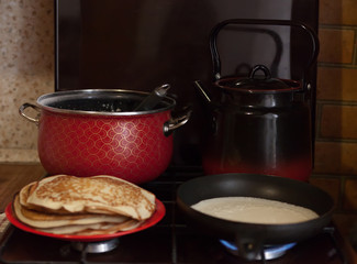 Frying pancakes on   dark stove