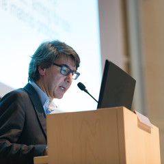 Speaker giving talk on podium at Business Conference. Business and Entrepreneurship. Expert...