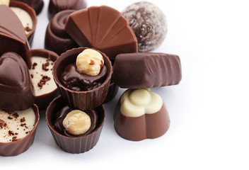 Assorted collection of chocolate candies and sweets, isolated on white