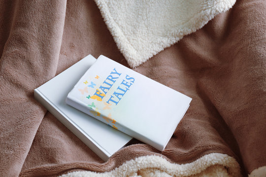 Books on soft blanket. Peace and comfort concept