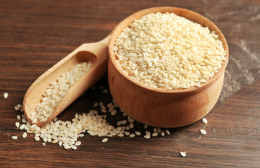 Sesame seeds on wooden table background, closeup