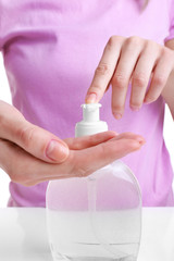 Woman using liquid soap, closeup
