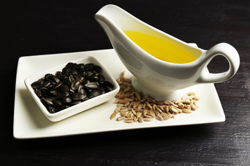 Sunflower seeds with oil on wooden table