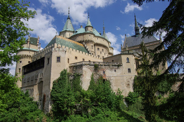 Fototapeta na wymiar View on medieval Bojnice castle with gothic tower and colorful roof near Prievidza city,Slovakia