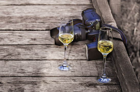 Two glasses of champagne and a photo camera