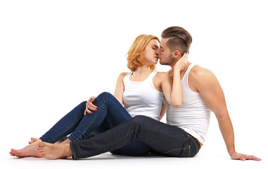 Young couple in love kissing and sitting together, isolated on white