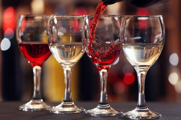 Red wine pouring into wine glass, closeup