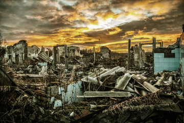 Apocalyptic landscape.The remains of destroyed houses at sunset - obrazy, fototapety, plakaty