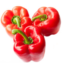 Three red peppers, isolated on white background