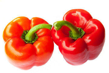 Two red peppers, isolated on white background